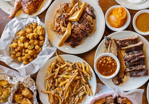 Plates of BBQ and side dishes served by Smokin' Notes BBQ