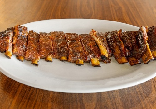 A rack of smoked ribs, prepared by Smokin' Notes BBQ